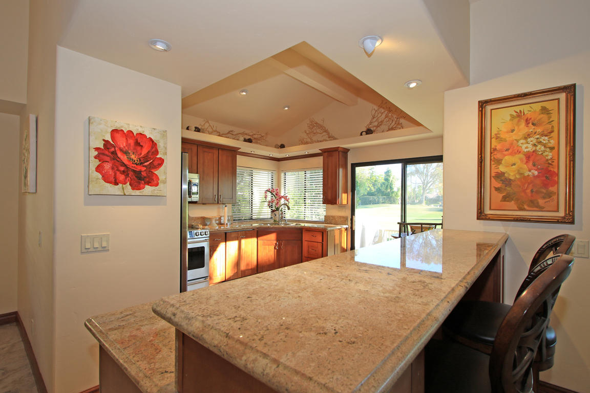 210 Wagon Wheel Road Palm Desert, CA 92211 - Photo 10 of 27 a large kitchen with stainless steel appliances granite countertop a sink and a refrigerator