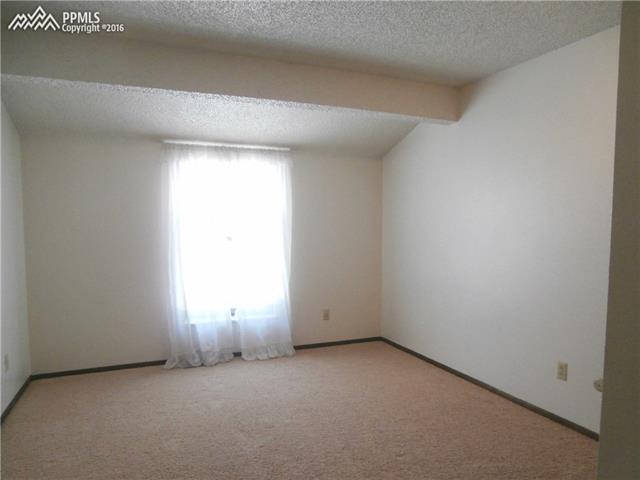 2870 Valencia Road Colorado Springs, CO 80917 - Photo 12 of 20 Upper level bedroom looks out to upper deck