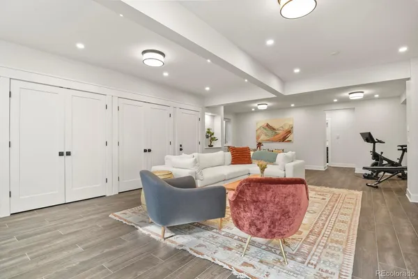 a living room with furniture and a wooden floor