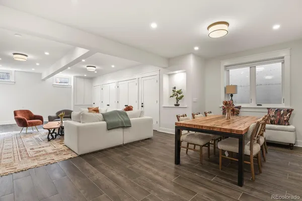 a living room with furniture a wooden floor and a sink