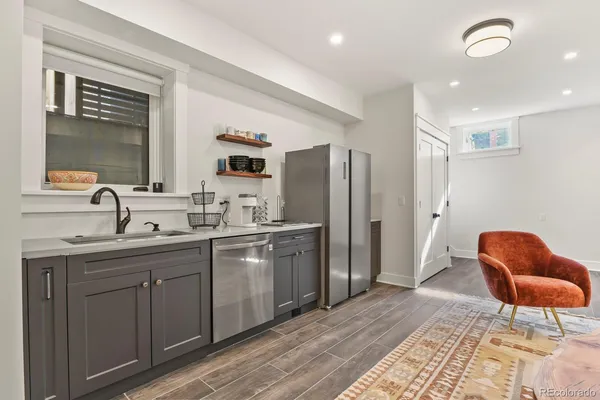 a kitchen with stainless steel appliances granite countertop a sink and a refrigerator