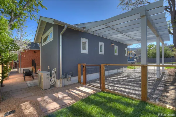 a view of backyard with a chair and table in the patio