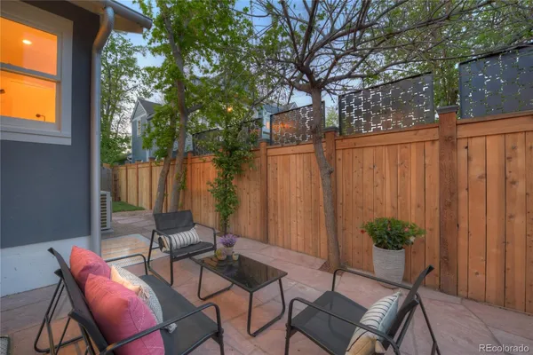 a view of a chairs and table in backyard
