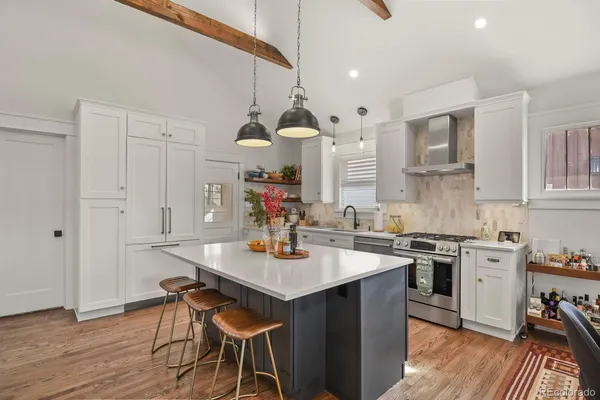 a kitchen with a table chairs stove and cabinets