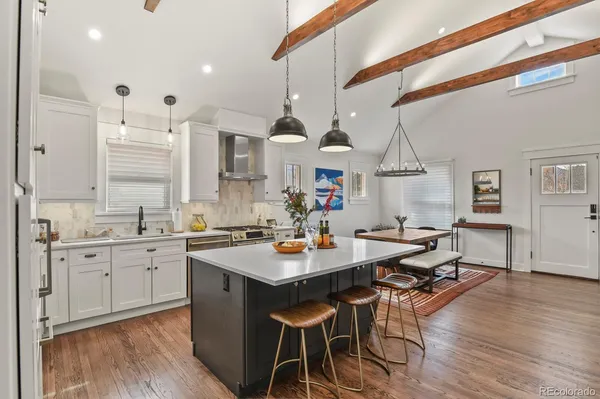 a kitchen with a sink dining table and chairs