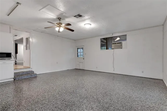 a view of empty room with ceiling fan