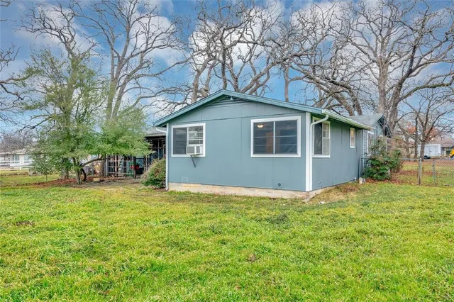 a house that has a tree in front of it
