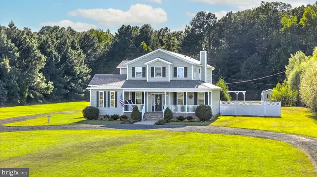 a front view of a house with swimming pool yard and outdoor seating