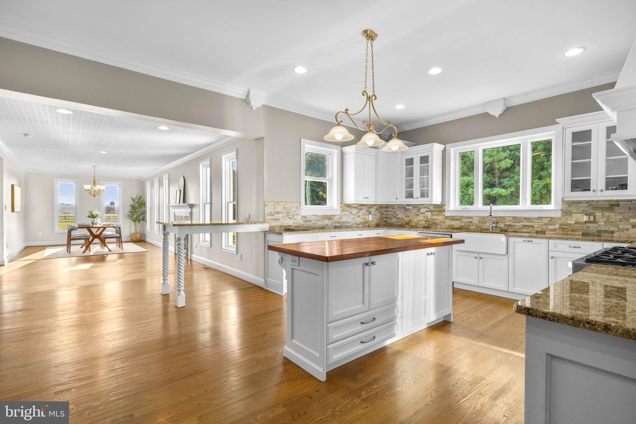 23135 Grampton Road Clements, MD 20624 - Photo 16 of 50 a large kitchen with kitchen island lots of counter space a sink a window and dining table