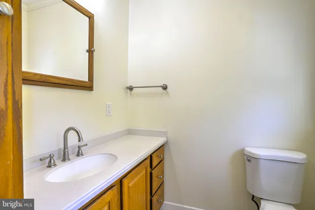 a bathroom with a sink a toilet and mirror