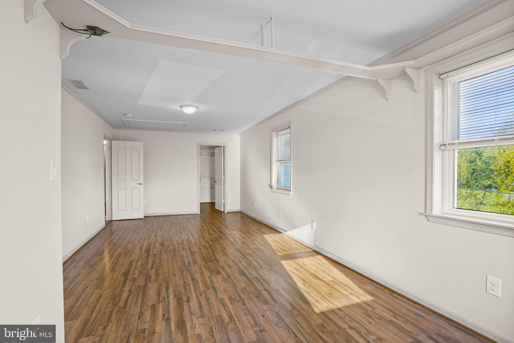 23135 Grampton Road Clements, MD 20624 - Photo 28 of 50 a view of an empty room with wooden floor and a window