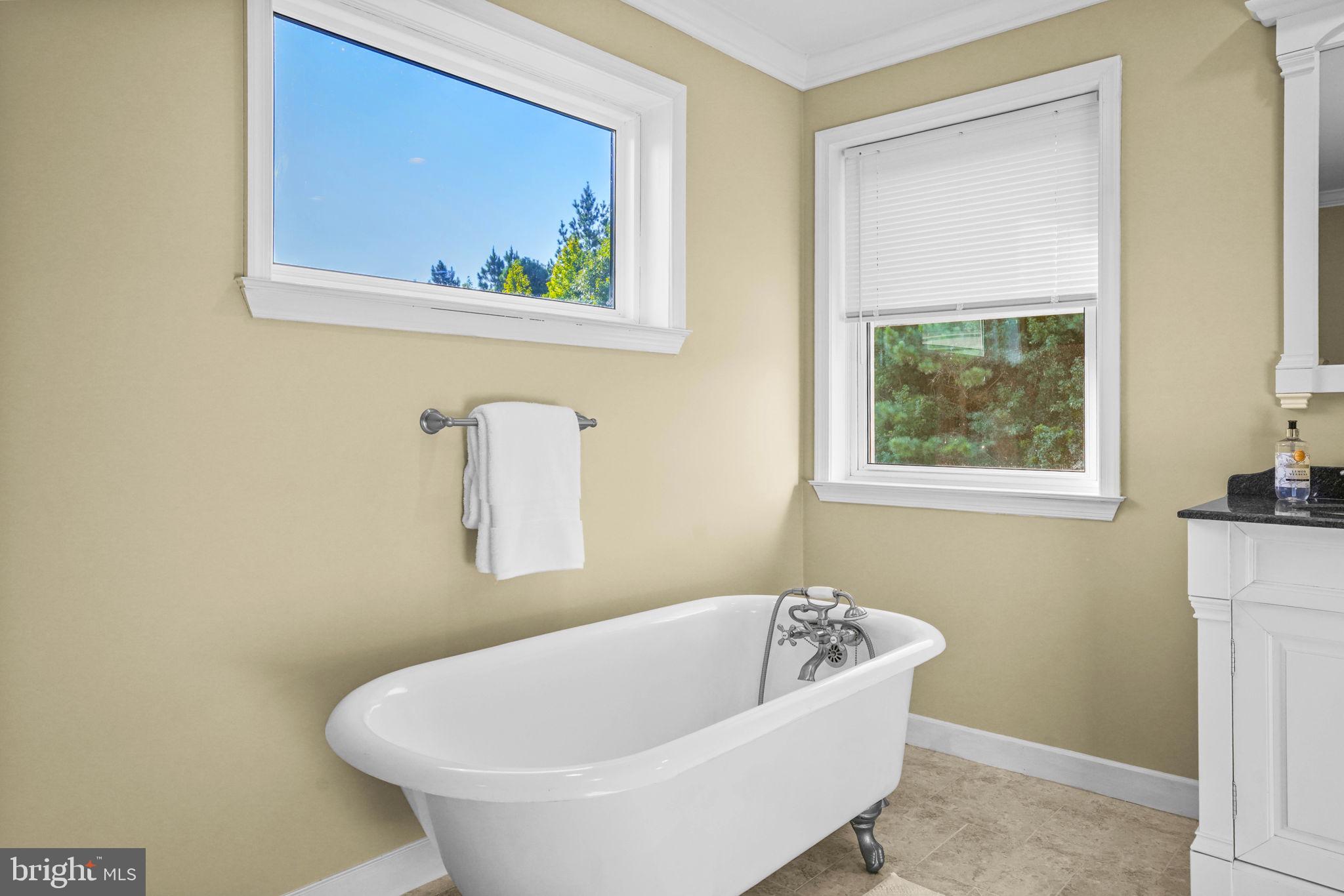 23135 Grampton Road Clements, MD 20624 - Photo 38 of 50 a white bath tub sitting in a bathroom next to a window