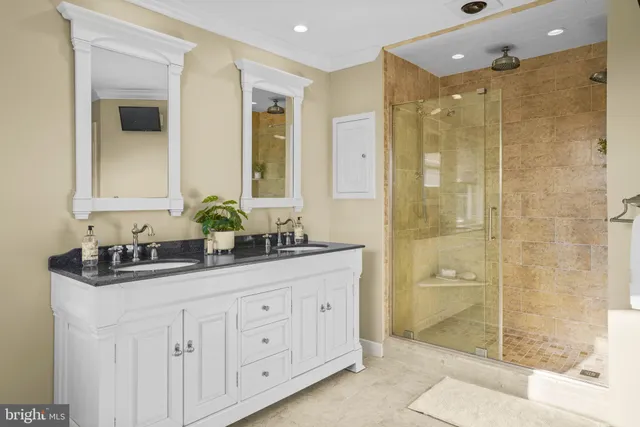 a bathroom with a granite countertop sink mirror and shower