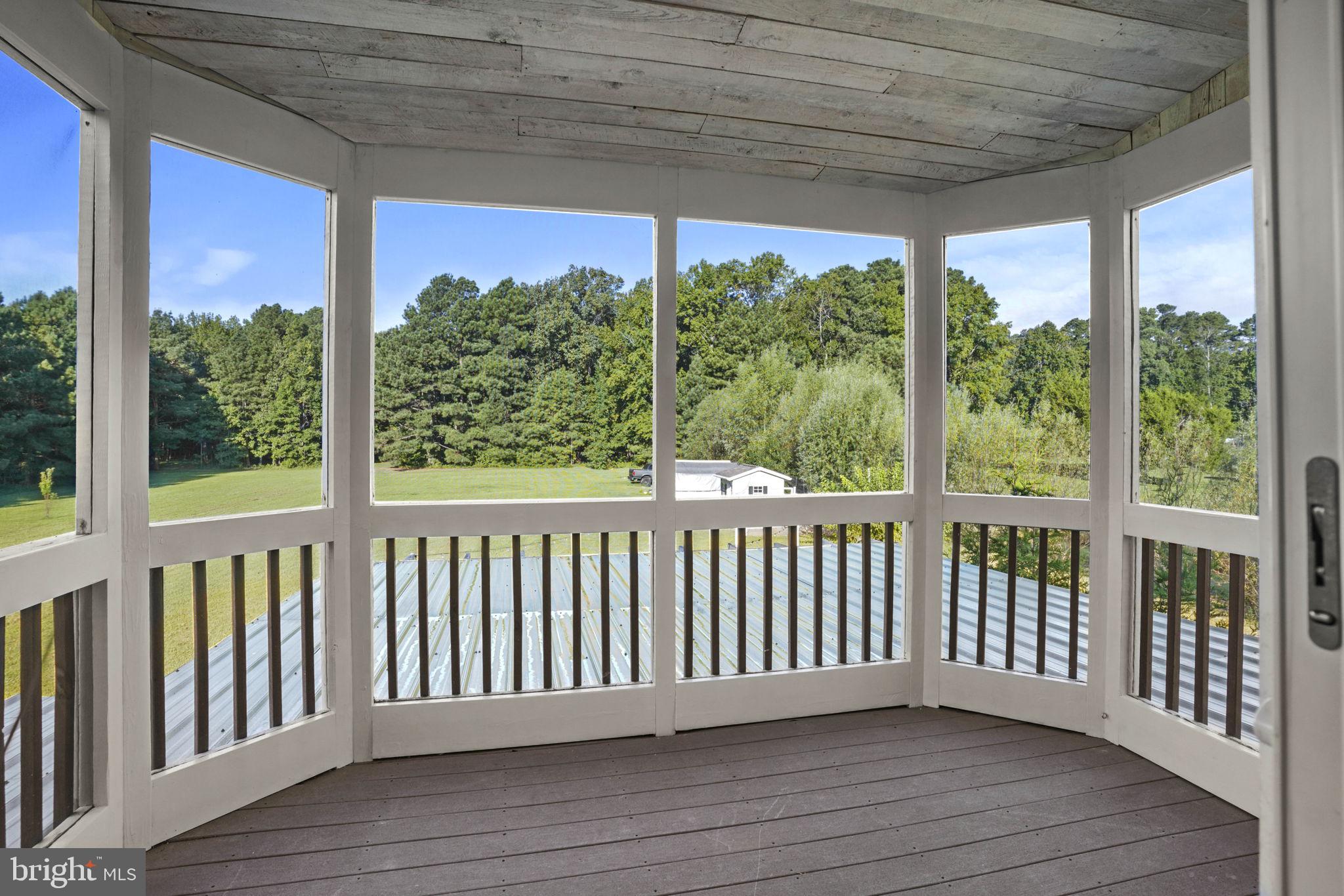 23135 Grampton Road Clements, MD 20624 - Photo 40 of 50 a view of a wooden balcony with a chairs