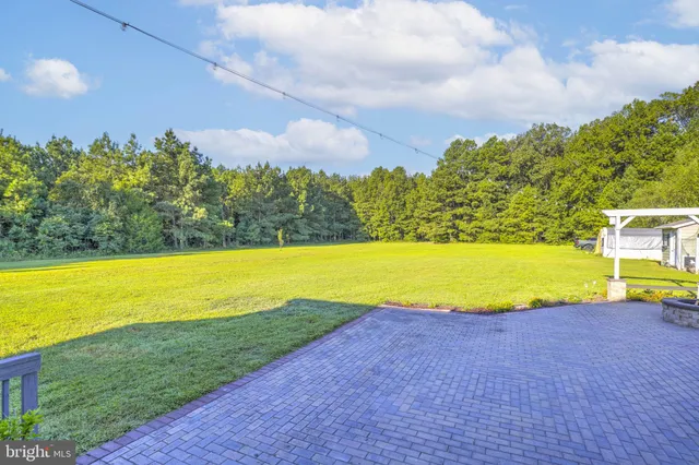 a view of a swimming pool with an outdoor space and seating area
