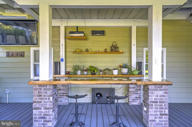 a view of a living room with a table and chairs