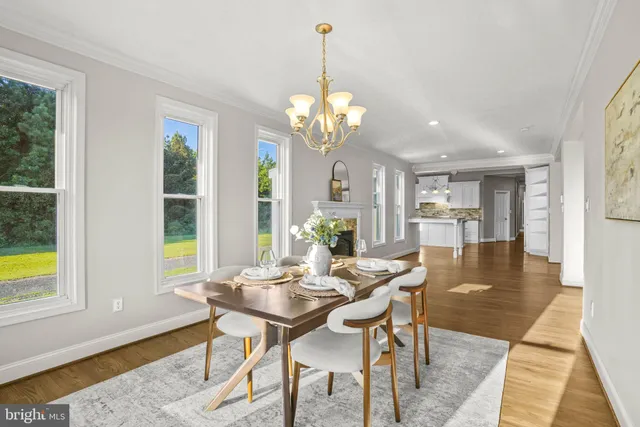 a view of a dining room with furniture and a chandelier