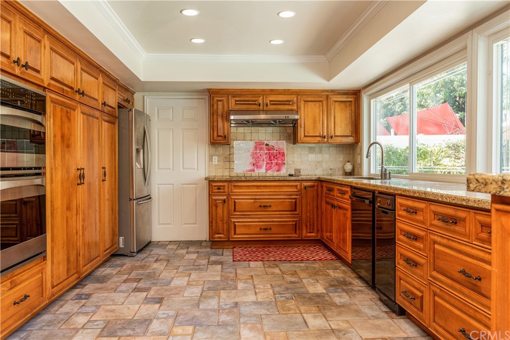 331 Bagnall Avenue Placentia, CA 92870 - Photo 13 of 37 a kitchen with stainless steel appliances kitchen island granite countertop a refrigerator and a stove