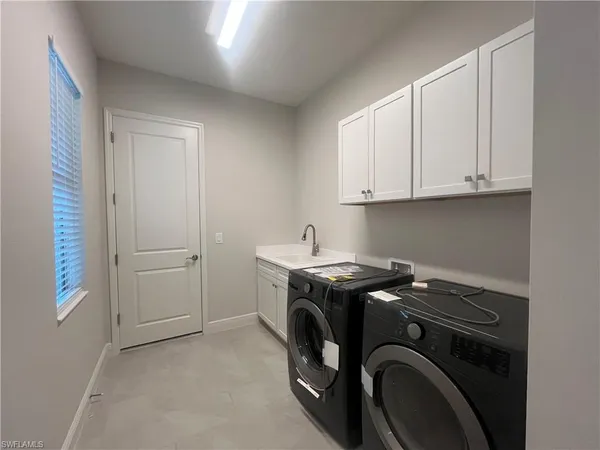 a bathroom with a sink shower and a mirror