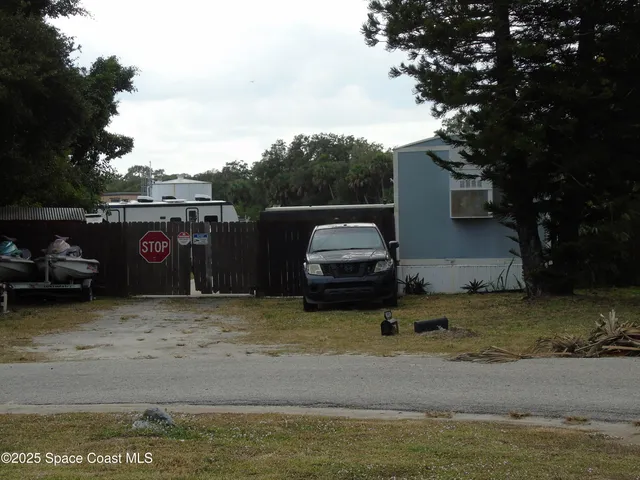 a view of a ocean with truck parked on the road