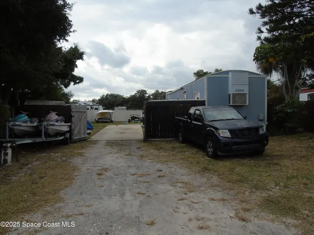 a view of a car parked in back of a house