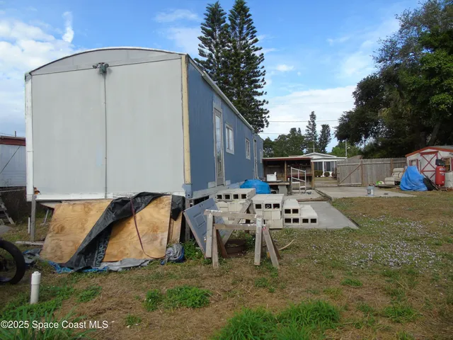 a view of backyard with a table and chairs