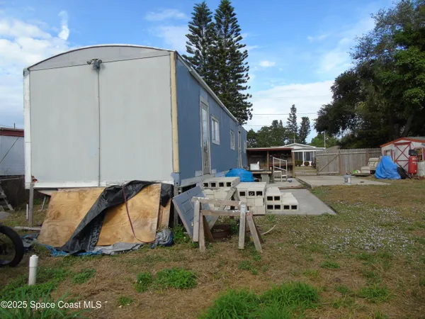 a view of backyard with a table and chairs