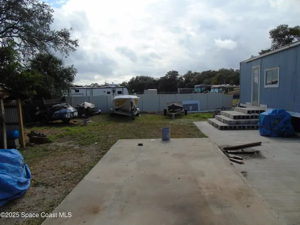 a view of a backyard with sitting area