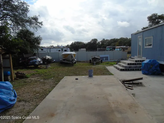 a view of a backyard with sitting area