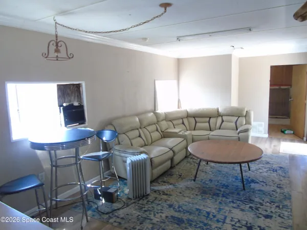 a living room with furniture a rug and a chandelier