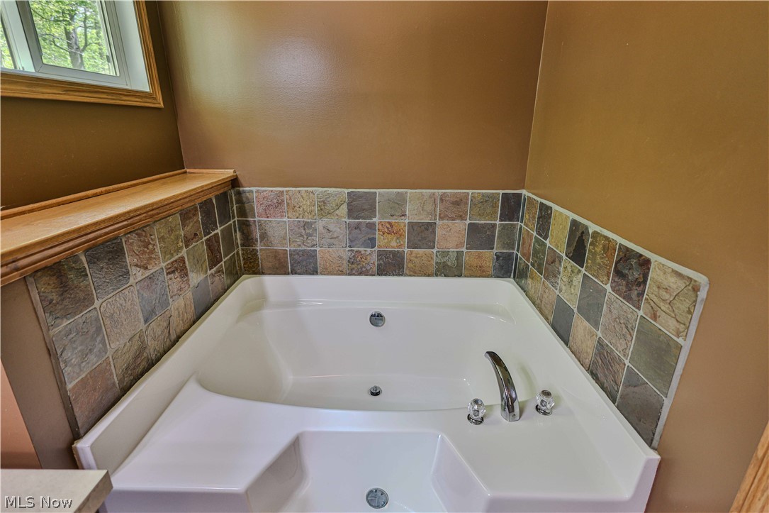 11154 Johnsford Road Southwest Beach City, OH 44608 - Photo 34 of 50 Corner soaking tub with integrated jets and chrome fixtures
