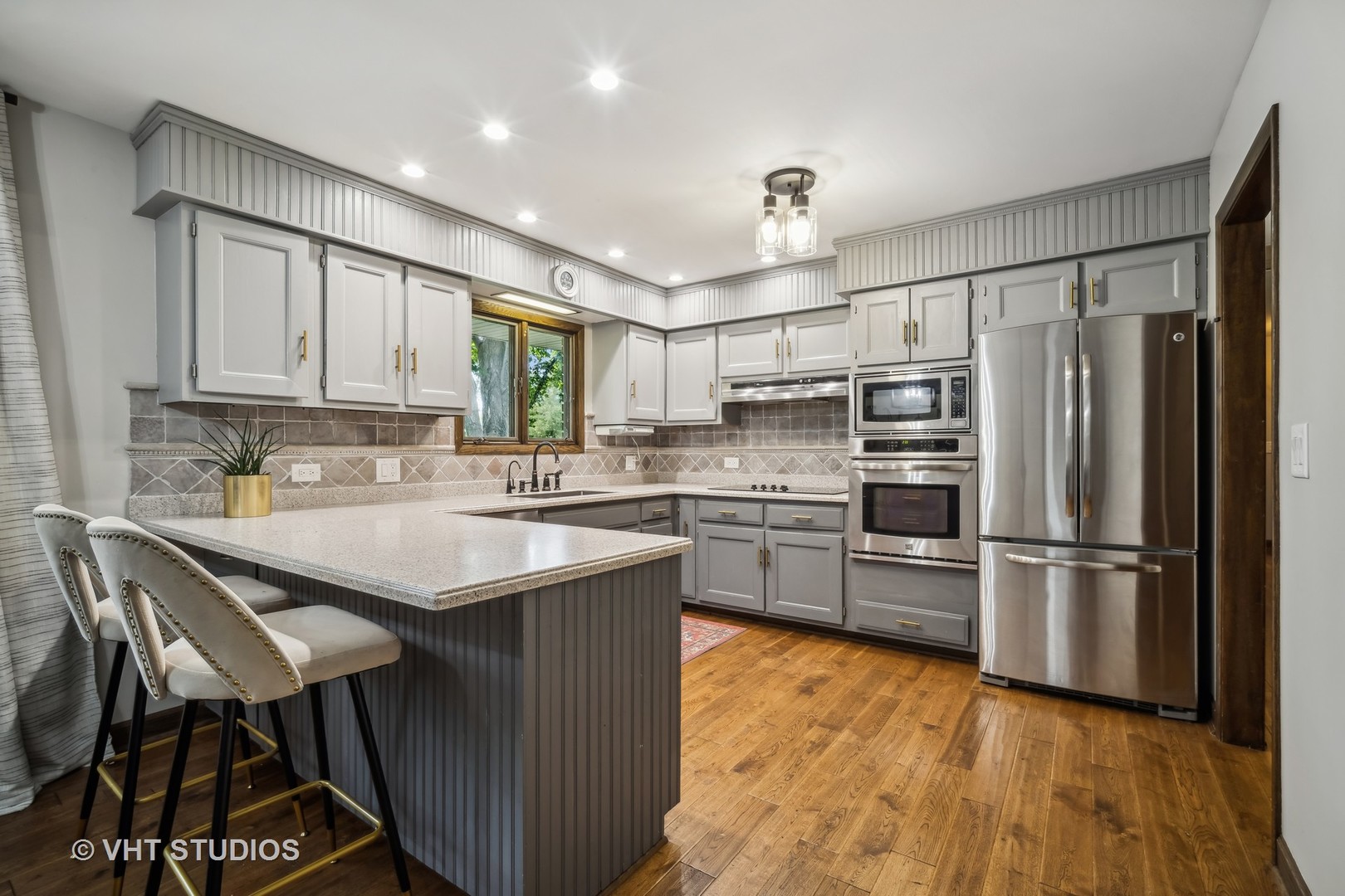 4N600 Klein Road West Chicago, IL 60185 - Photo 5 of 23 a kitchen with kitchen island a sink table and chairs