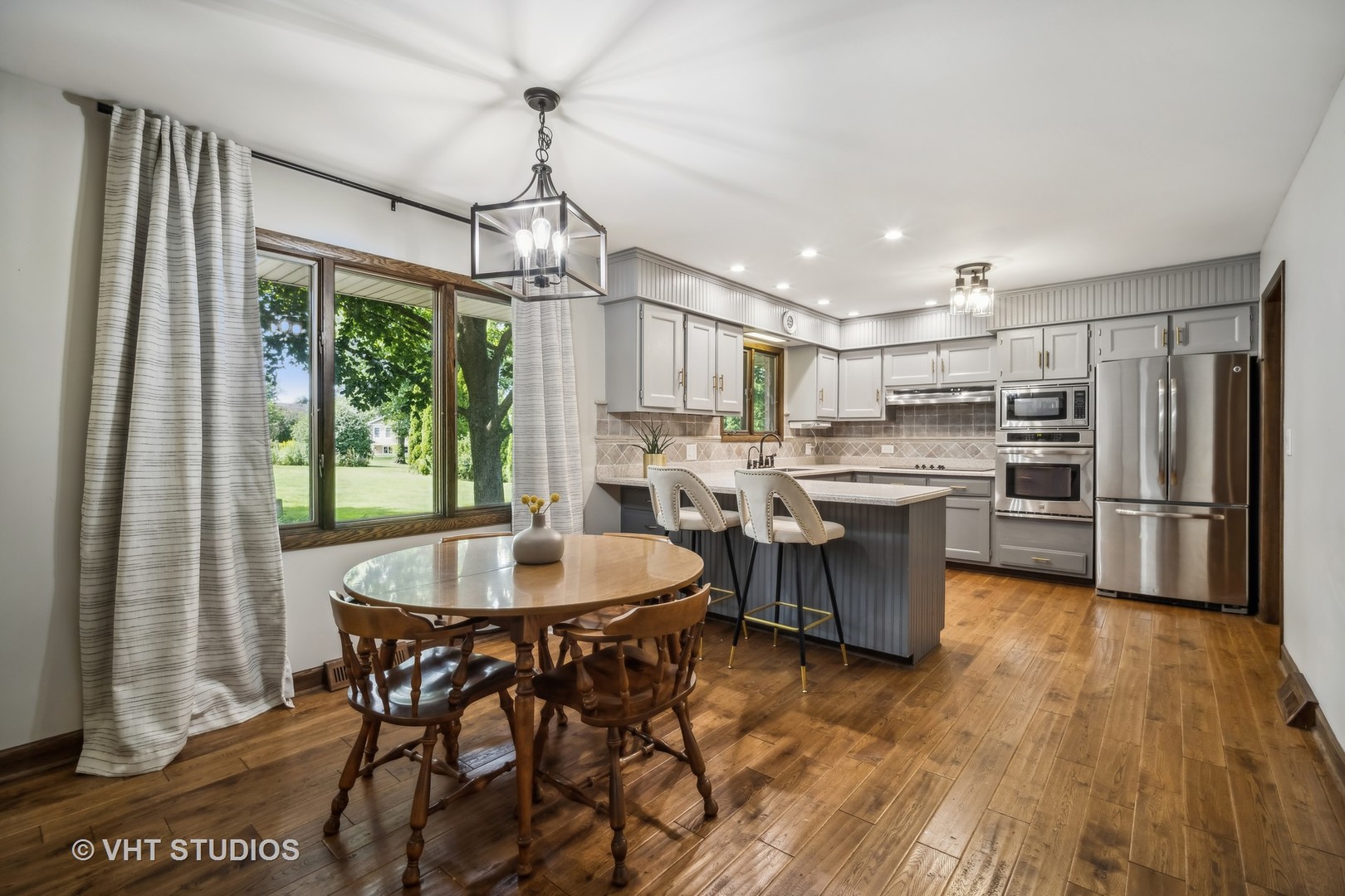 4N600 Klein Road West Chicago, IL 60185 - Photo 7 of 23 a kitchen with a table chairs refrigerator and cabinets