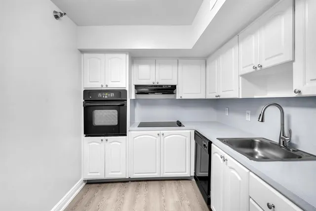 a kitchen with stainless steel appliances granite countertop a sink and a microwave