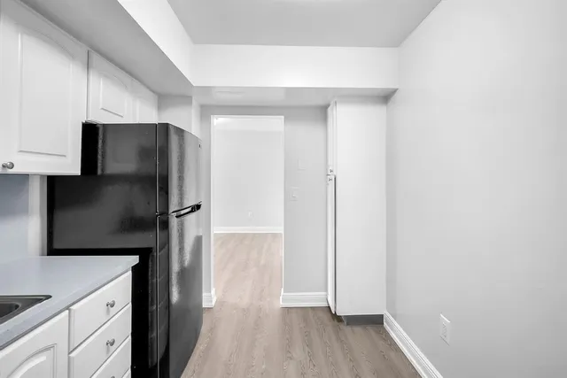 a kitchen with a refrigerator and a sink