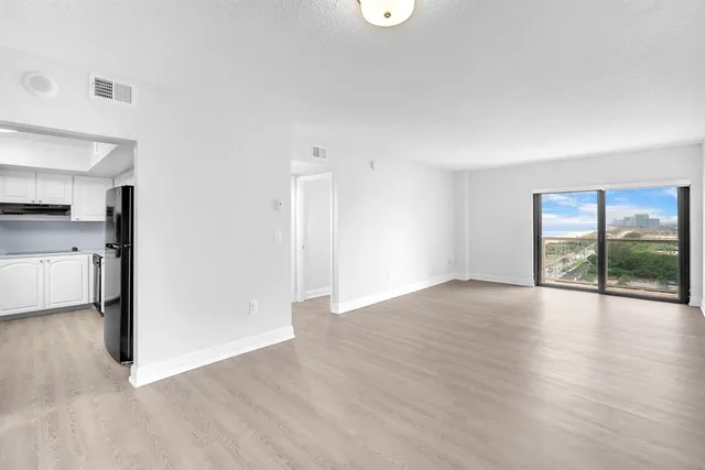 a view of a kitchen with a sink and a window