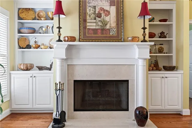 a living room with stainless steel appliances kitchen island granite countertop furniture and a chandelier