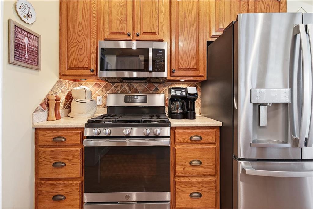 865 Laurel Ridge Road Cleveland, GA 30528 - Photo 22 of 81 a kitchen with stainless steel appliances granite countertop a stove a refrigerator and a microwave