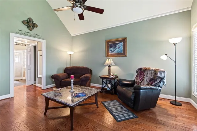a living room with furniture a fireplace and a chandelier