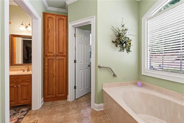a bathroom with a granite countertop sink mirror vanity and toilet