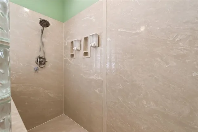 a living room with furniture a window and a flat screen tv