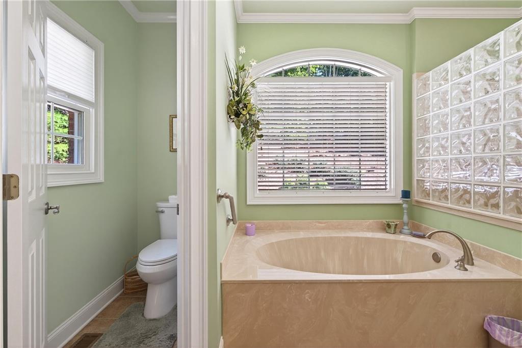 865 Laurel Ridge Road Cleveland, GA 30528 - Photo 40 of 81 a bathroom with a bathtub a window and a shower