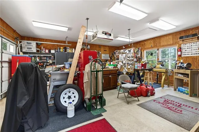 a view of a house with a big yard and large trees