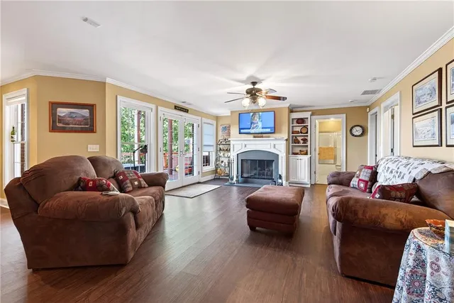 a view of a house with a big yard and large trees