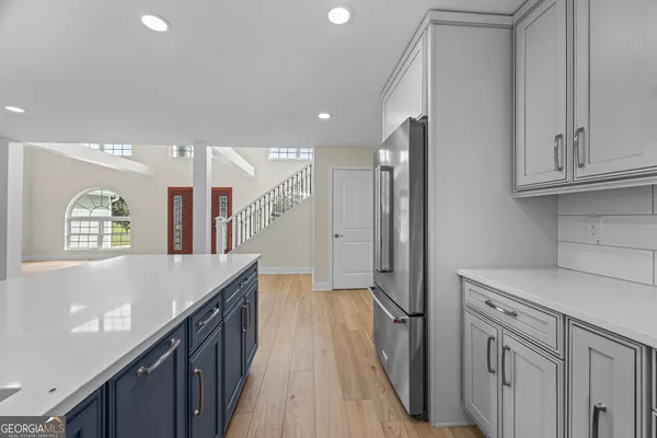 a view of staircase with white walls and wooden floor
