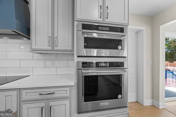 a bathroom with a granite countertop sink a toilet and a mirror
