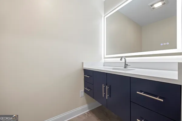an empty room with wooden floor and stairs