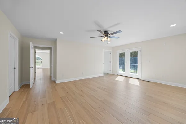 a view of an empty room with wooden floor