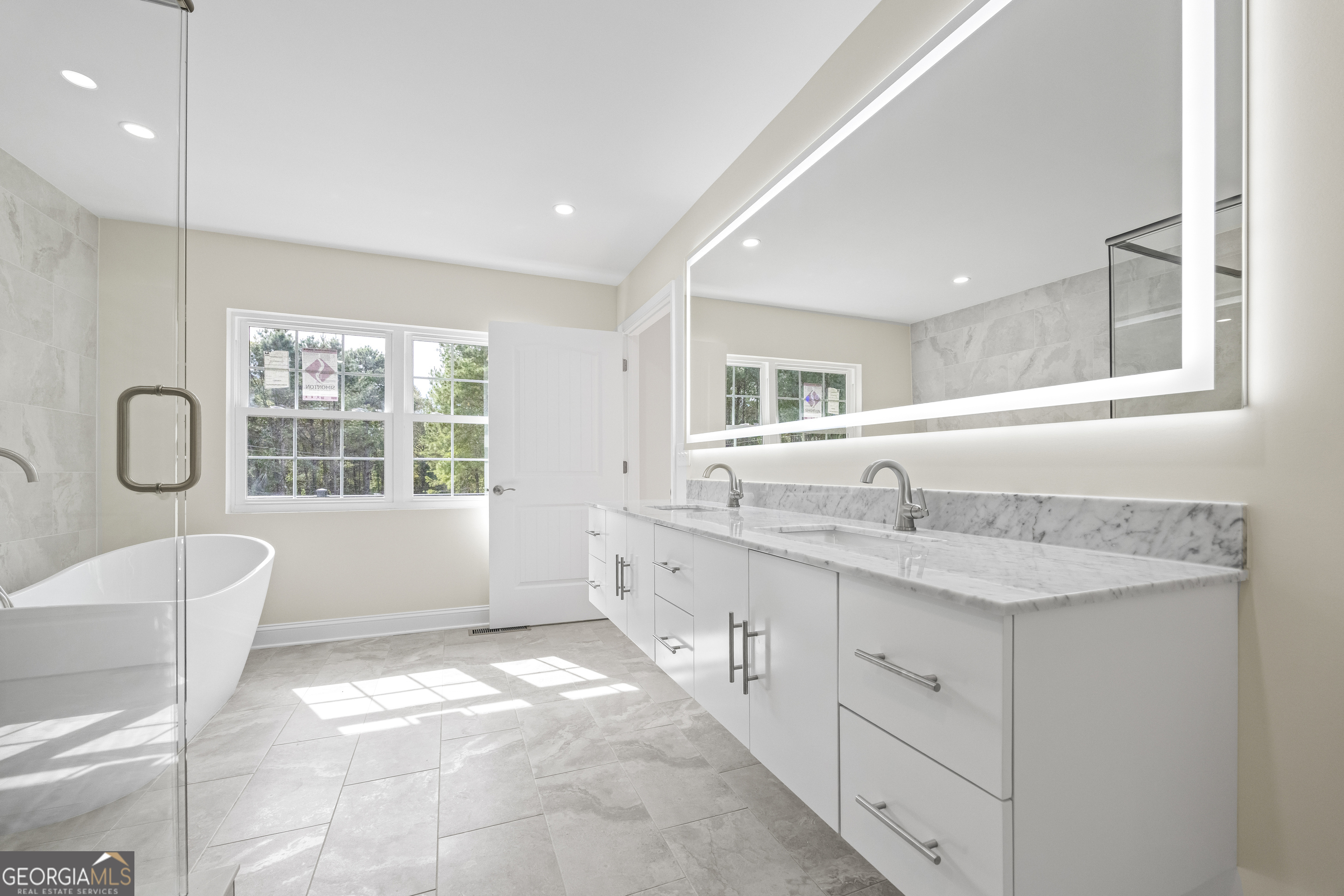 22 Anderson Thomas Road Martin, GA 30557 - Photo 48 of 110 a spacious bathroom with a granite countertop tub a double vanity sink a mirror and a window