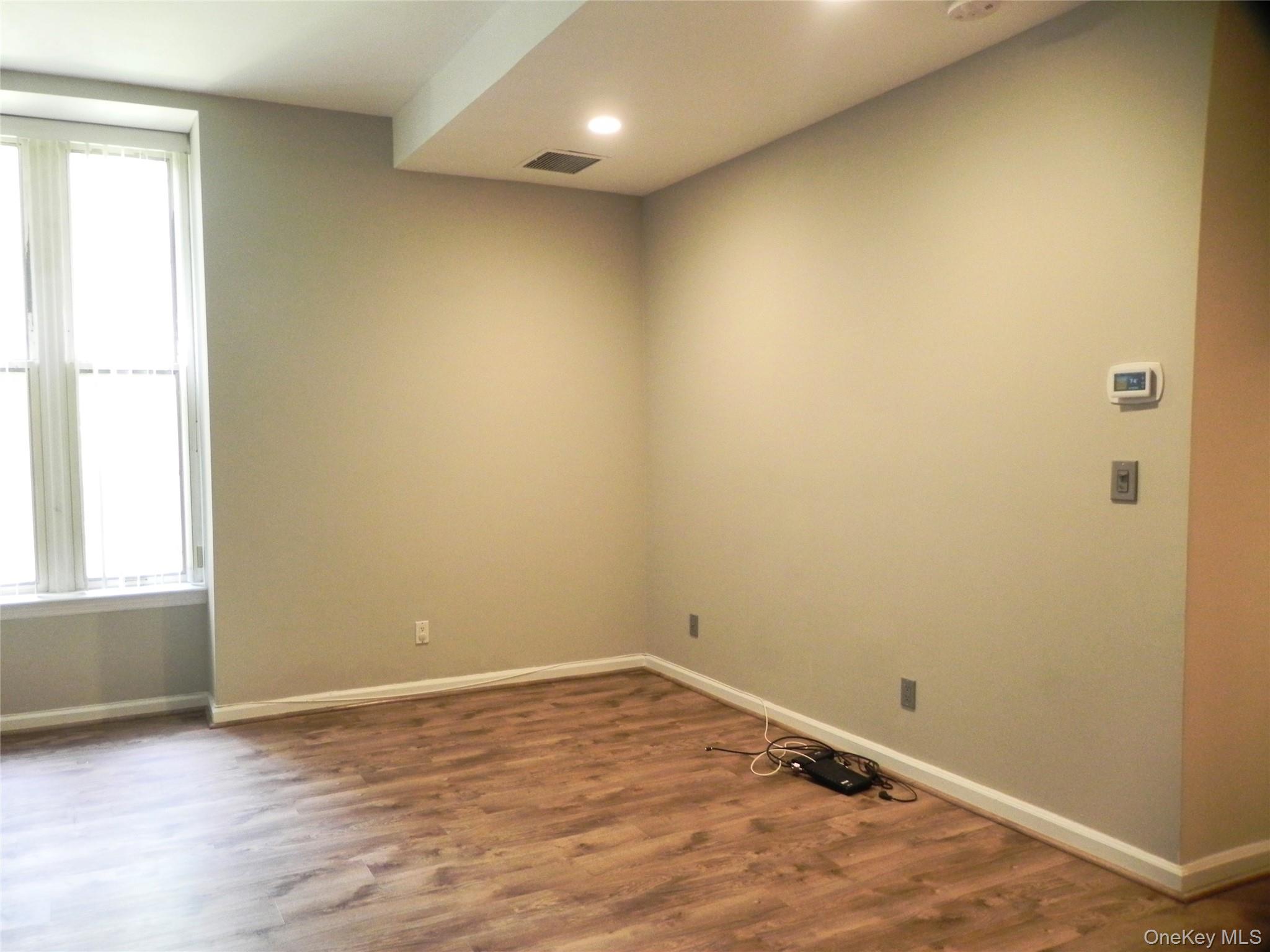 1250 North Avenue, Unit 110 New Rochelle, NY 10804 - Photo 7 of 27 Empty room featuring healthy amount of natural light, wood finished floors, and recessed lighting